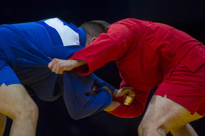 Two sambo fighters in a grappling position