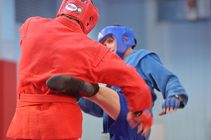 Sambo practitioners sparring in a gym