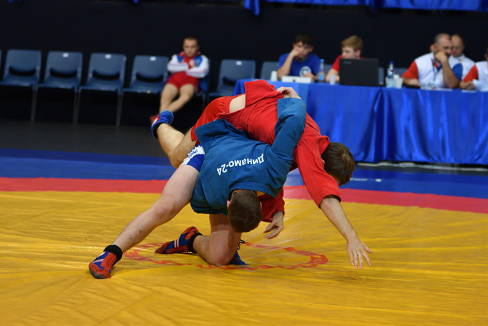 Sambo competition with two fighters wrestling for position