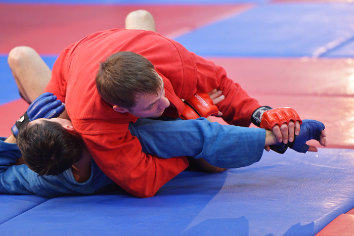 Sambo practitioner performing submission on opponent