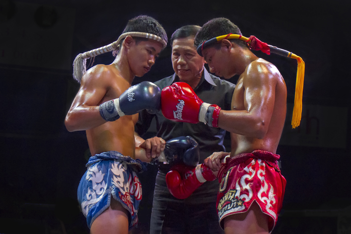 Muay Thai fighters touching gloves