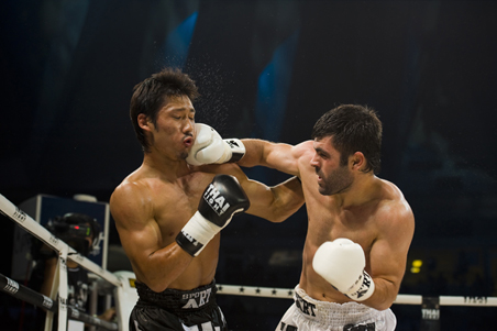 Two Muay Thai fighters fighting in a ring