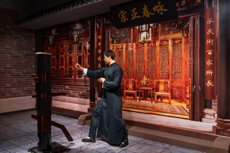 Donnie Yen dressed as Ip Man as a figure in a museum