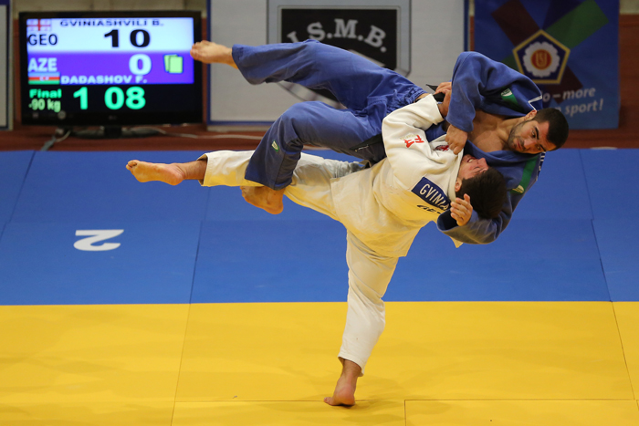 Judo competition with practitioners performing a throw