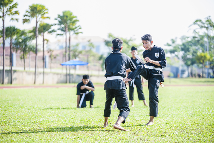 Silat practitioners practicing in an outdoor area