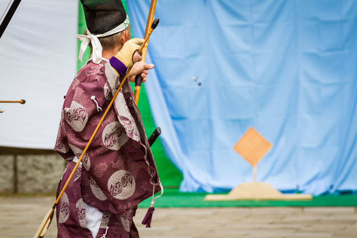 A kyudo practitioner shooting an arrow at a target