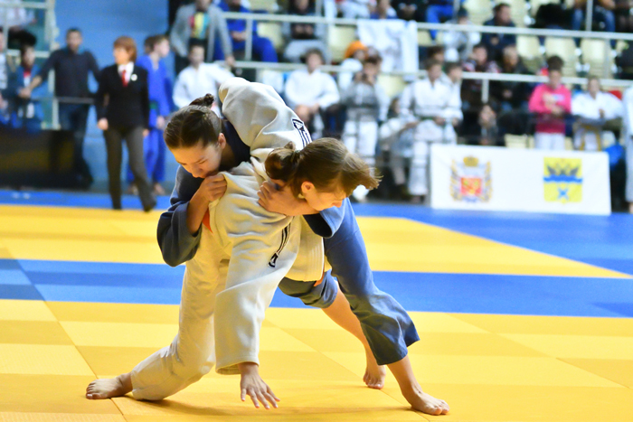 Two Judokas fighting for position in a Judo competition