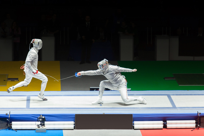 Two fencers competing at a fencing competition