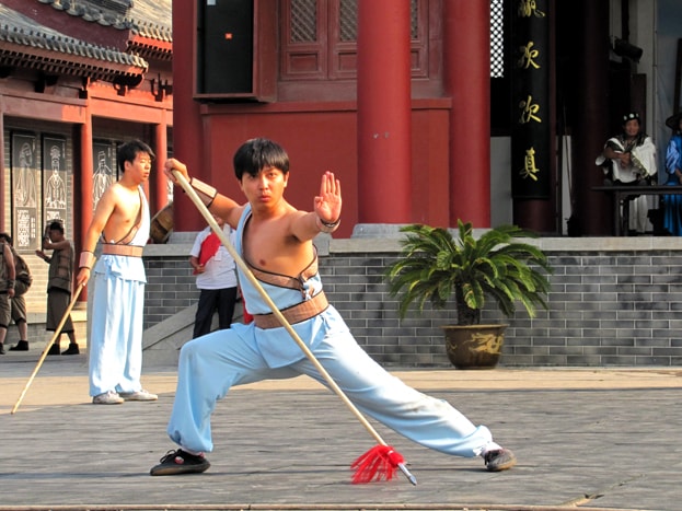 Shaolin Kung Fu student using a staff