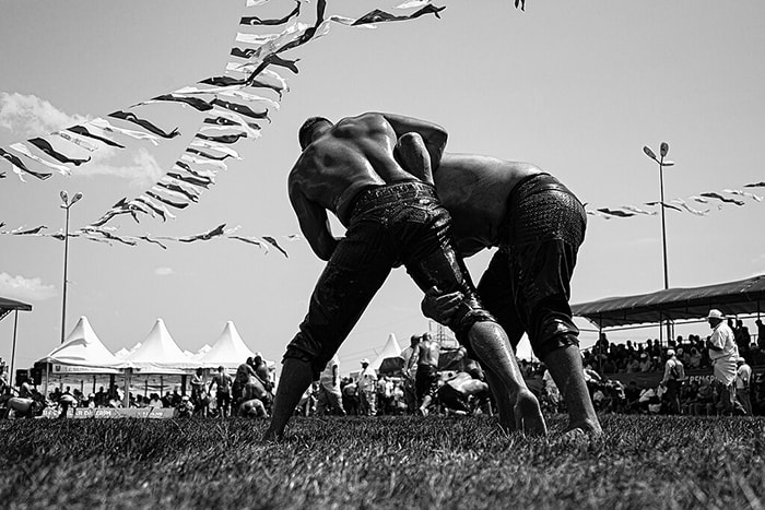 This is a photo of two oil wrestlers fighting for position