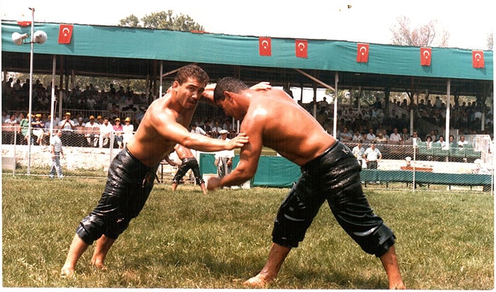 Two oil wrestlers competing in a match