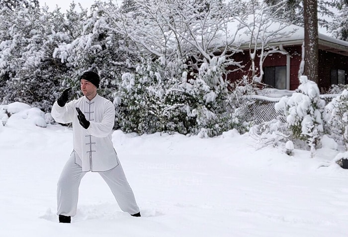 Chuan Fa practitioner performing a technique in a snowy setting