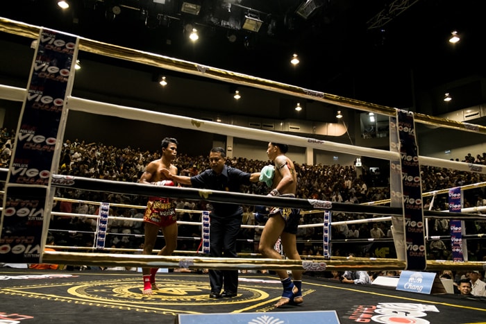 Muay Thai fighters in a ring about to begin a fight