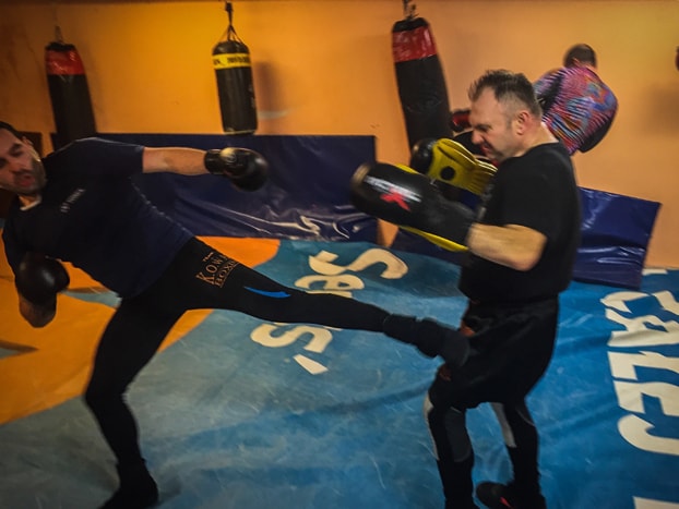 Two savate practitioners training at an academy