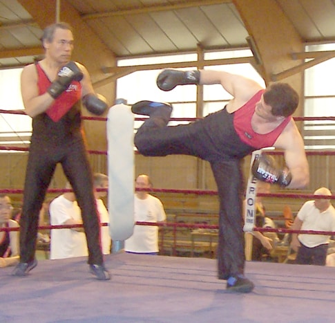 Savate practitioners training in a ring