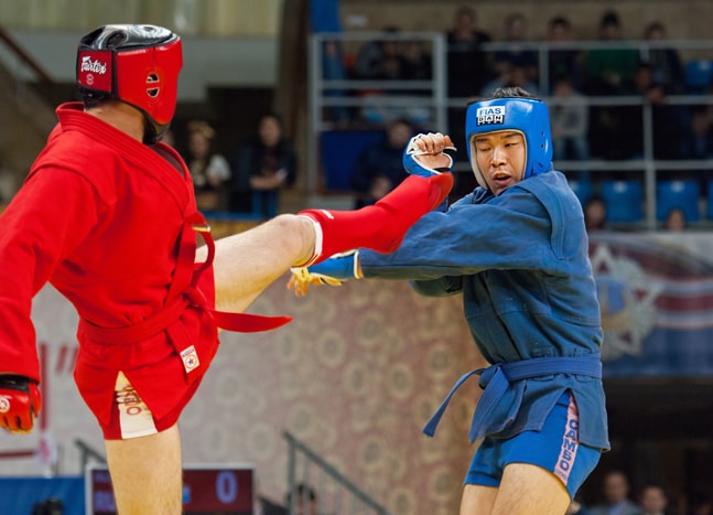 Combat Sambo competition taking place with two men fighting eachother