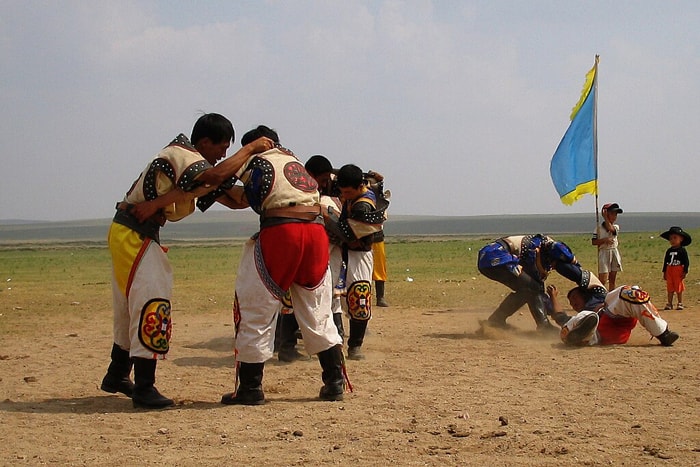 Two Mongolian wrestlers practicing their techniques on eachother