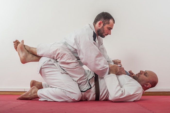 Brazilian jiu-jitsu practitioners practicing on the mat